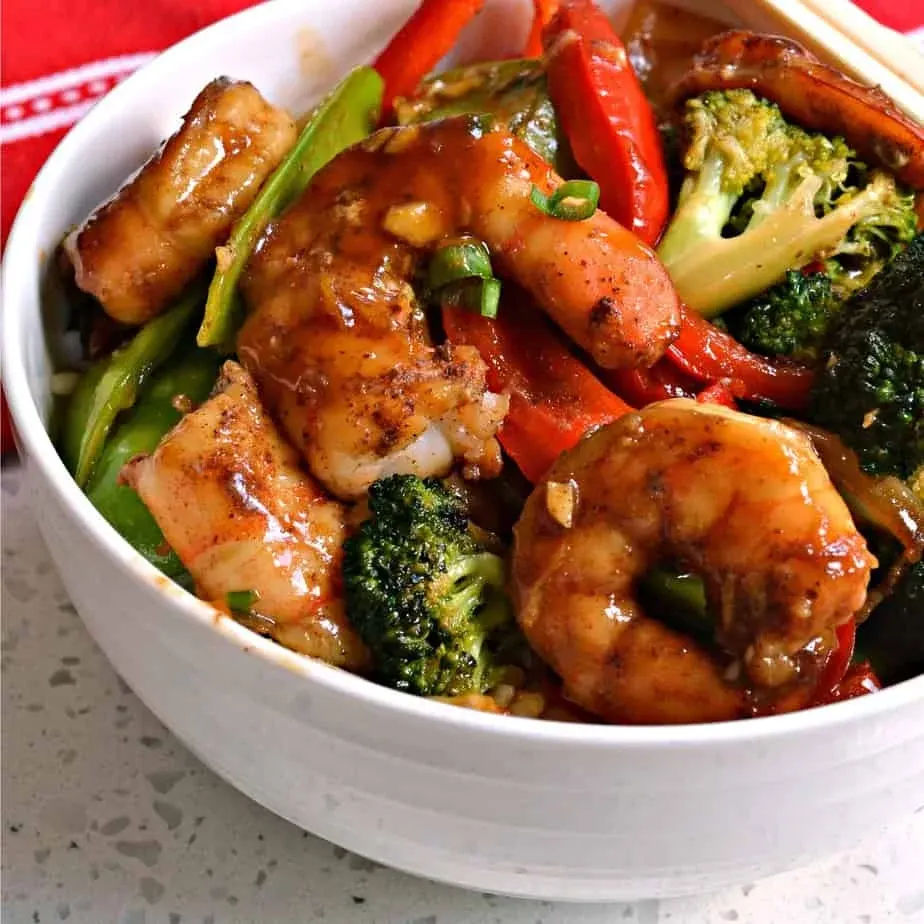 Shrimp stir-fry with broccoli and red peppers in savory brown sauce